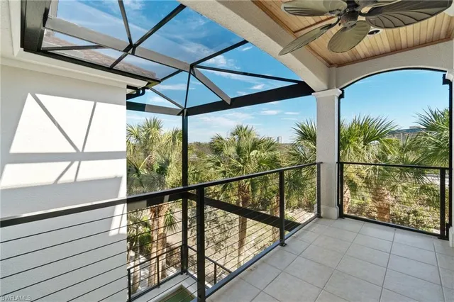 a spacious bedroom with a bed a couch and large window