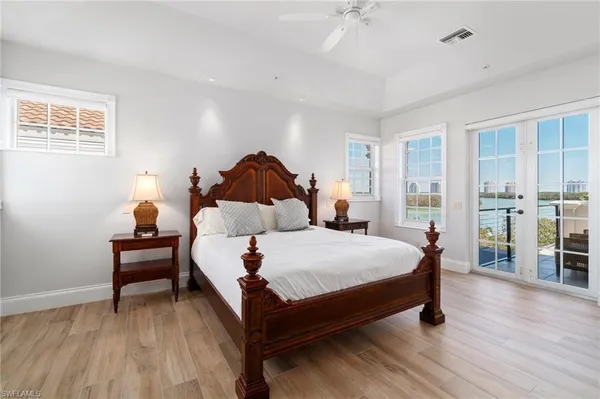 a spacious bathroom with a tub sink and mirror