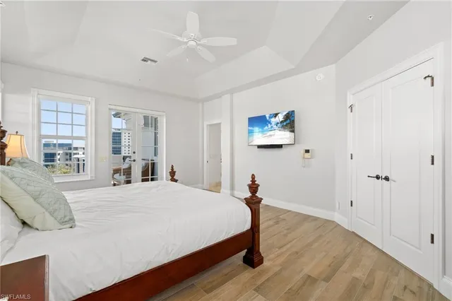 a bedroom with a bed and wooden floor