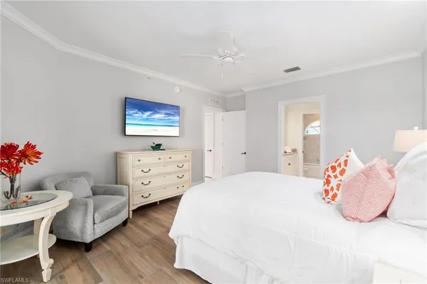 a bedroom with furniture and a flat screen tv