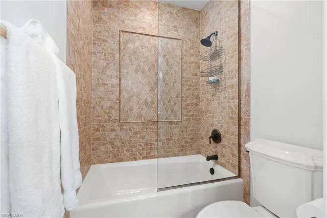 a en suite bathroom with a granite countertop tub and a mirror