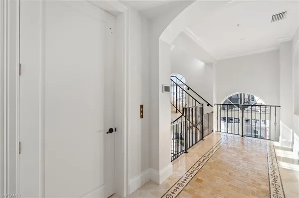 a kitchen with granite countertop white cabinets and window