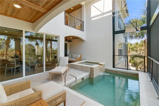 a balcony with table and chairs