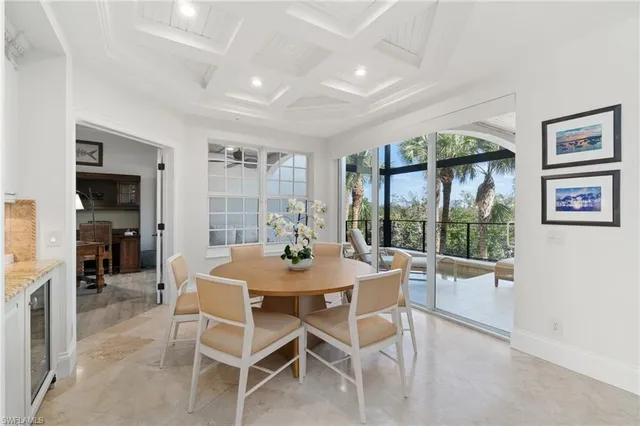 a view of a dining room with furniture large window and potted plants