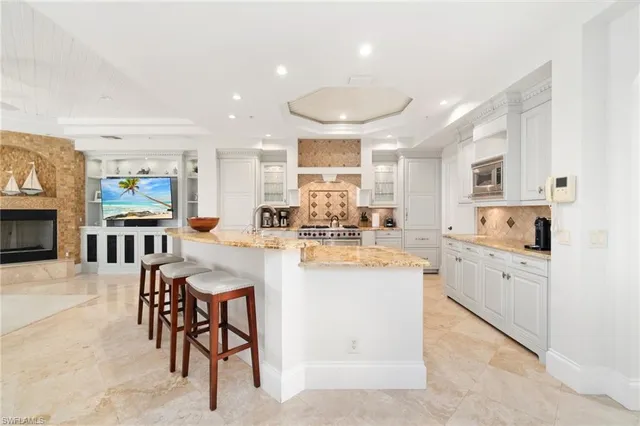 a kitchen with cabinets and chairs