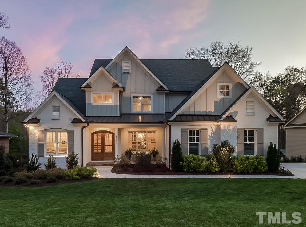 1101 Shelley Road Raleigh, NC 27609 - Photo 1 of 25 a front view of a house with a yard and trees