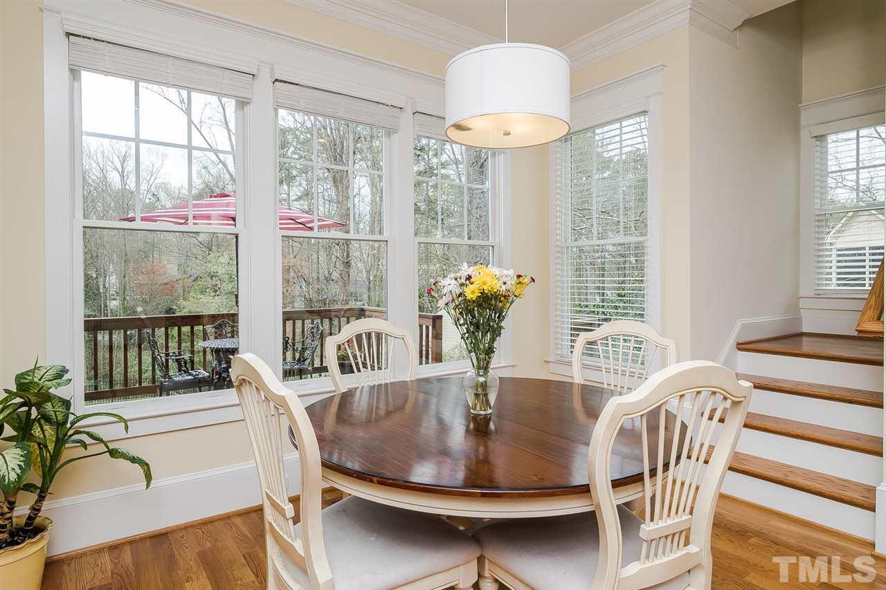 1101 Shelley Road Raleigh, NC 27609 - Photo 11 of 25 a dining room with furniture a chandelier and wooden floor