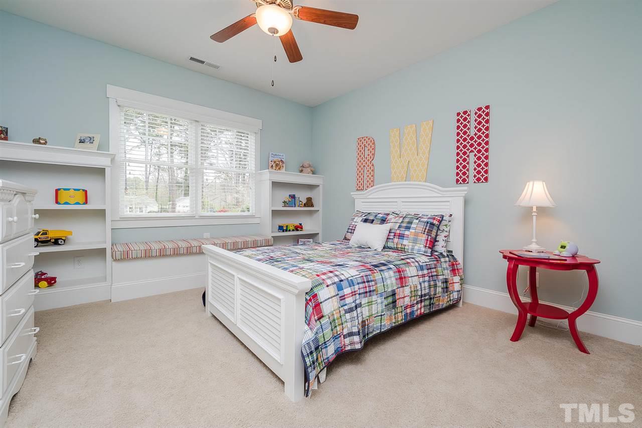 1101 Shelley Road Raleigh, NC 27609 - Photo 20 of 25 a bedroom with a bed and a chandelier