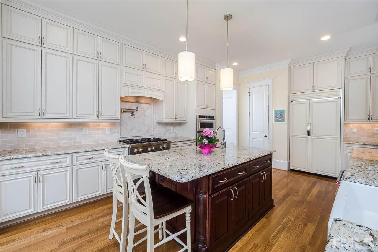1101 Shelley Road Raleigh, NC 27609 - Photo 9 of 25 a kitchen with granite countertop a sink cabinets and wooden floor