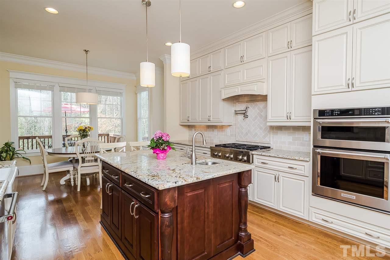 1101 Shelley Road Raleigh, NC 27609 - Photo 10 of 25 a kitchen with a stove cabinets and wooden floor