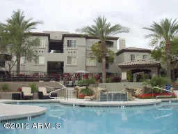 a front view of a house with a water fountain