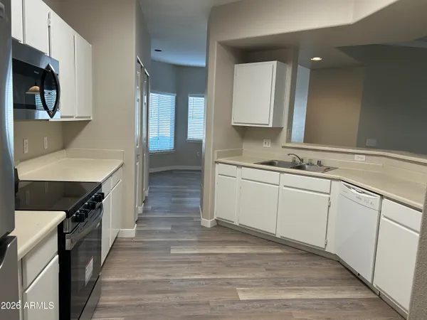 a kitchen with stainless steel appliances a sink stove and cabinets