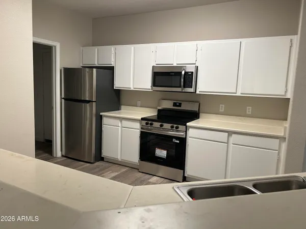 a kitchen with a refrigerator stove and microwave