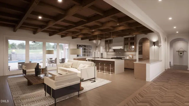 a living room with furniture a fireplace and a chandelier