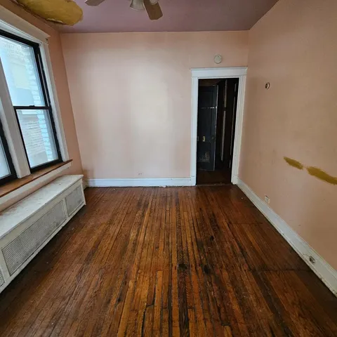 a view of a room with wooden floor and staircase