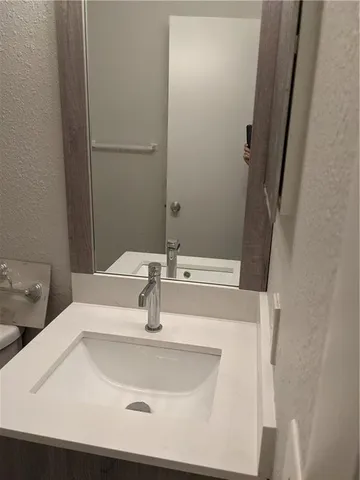 a white toilet sitting next to a bath tub