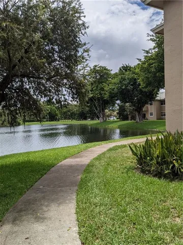 a view of a lake with houses in back