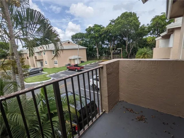 a view of balcony with deck and wooden fence