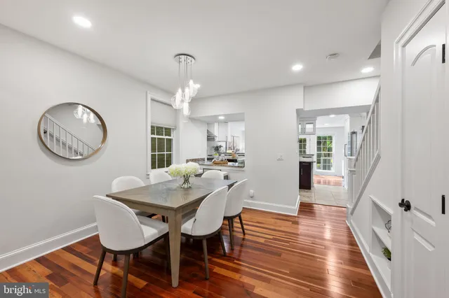 a view of a dining room with furniture a chandelier and wooden floor
