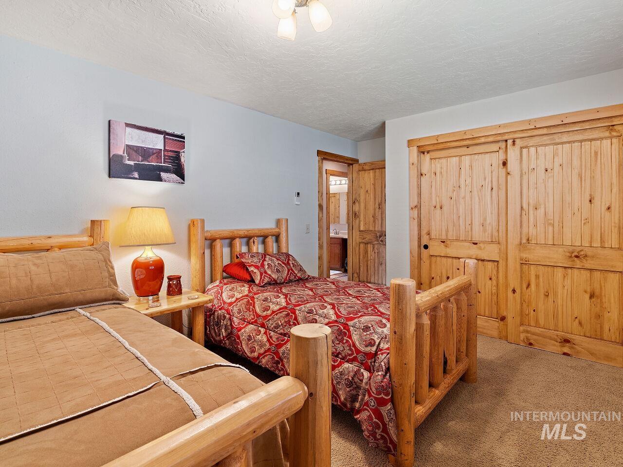 7438 Highway 95 Riggins, ID 83549 - Photo 36 of 36 Bedroom featuring carpet flooring, a closet, and a textured ceiling