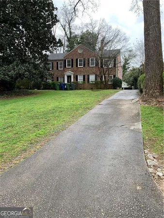 a front view of house with yard and green space
