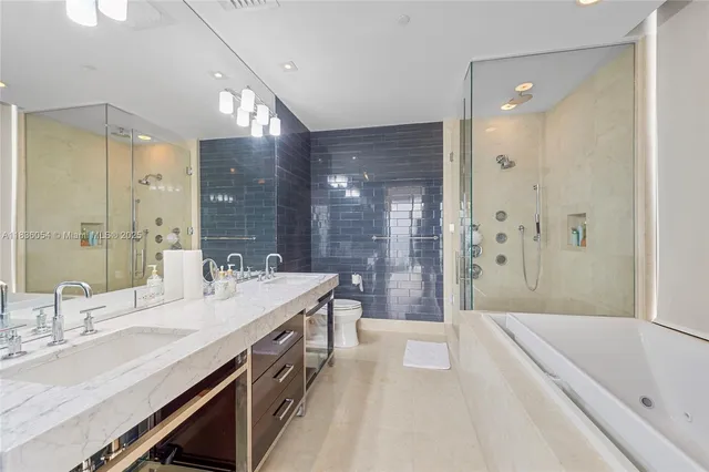 a spacious bathroom with a bathtub shower sink double and mirror