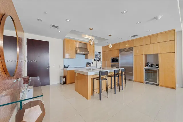 a large kitchen with a large counter top appliances and cabinets