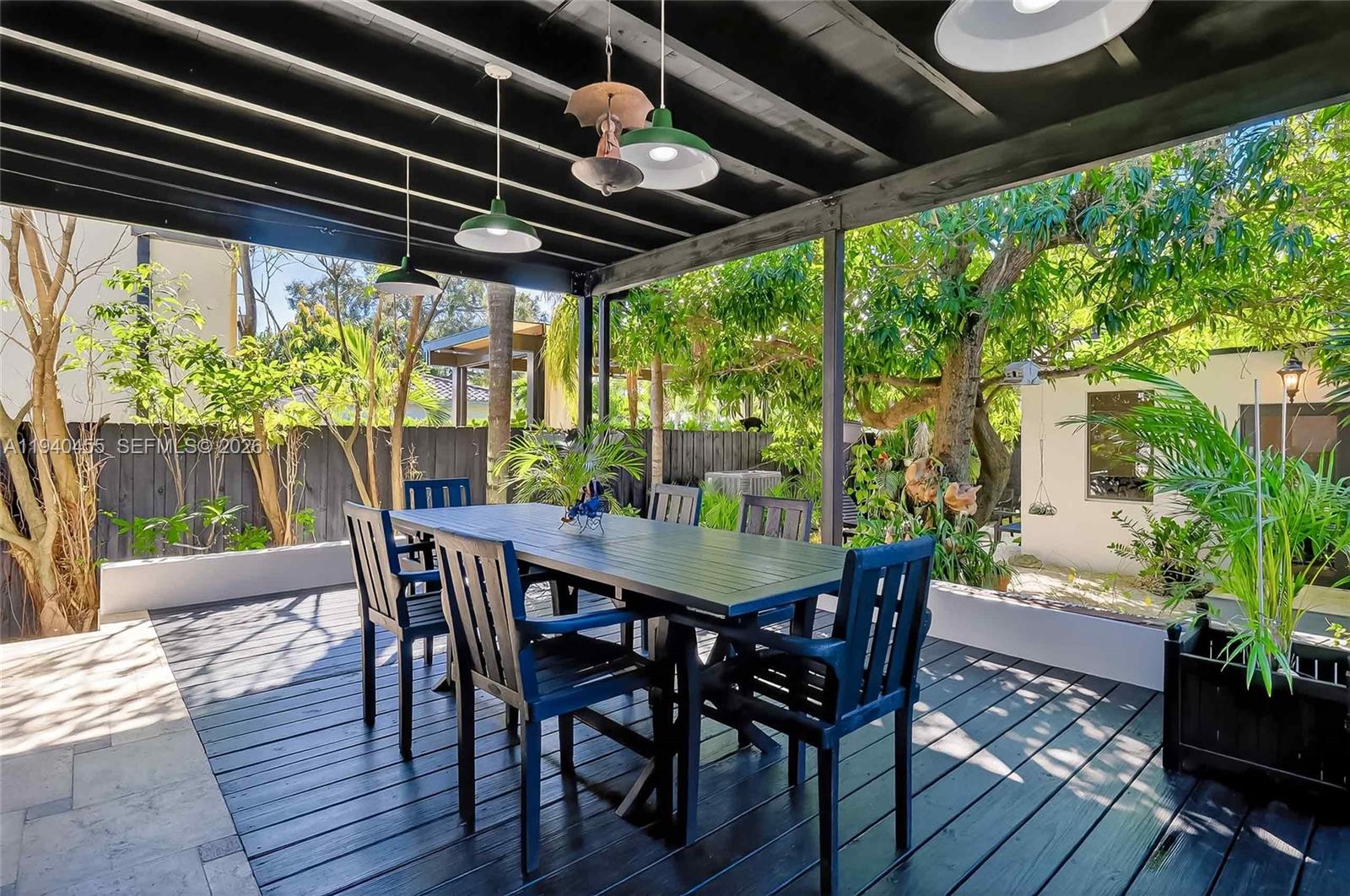 452 Southwest 21st Road Miami, FL 33129 - Photo 42 of 51 a view of a patio with table and chairs and potted plants