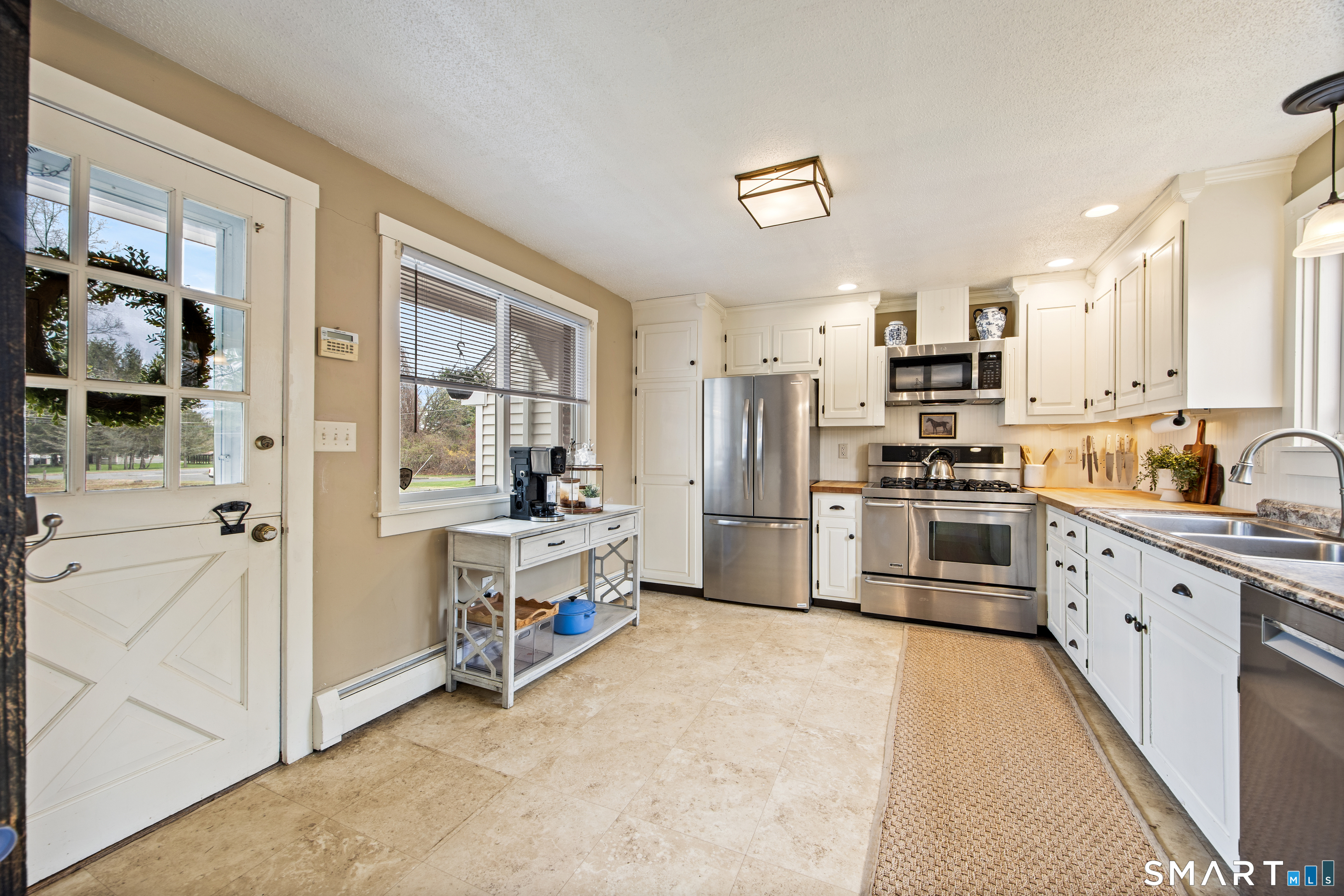 5 Livery Pool Road New Hartford, CT 06057 - Photo 13 of 40 a kitchen with stainless steel appliances a refrigerator and a stove top oven