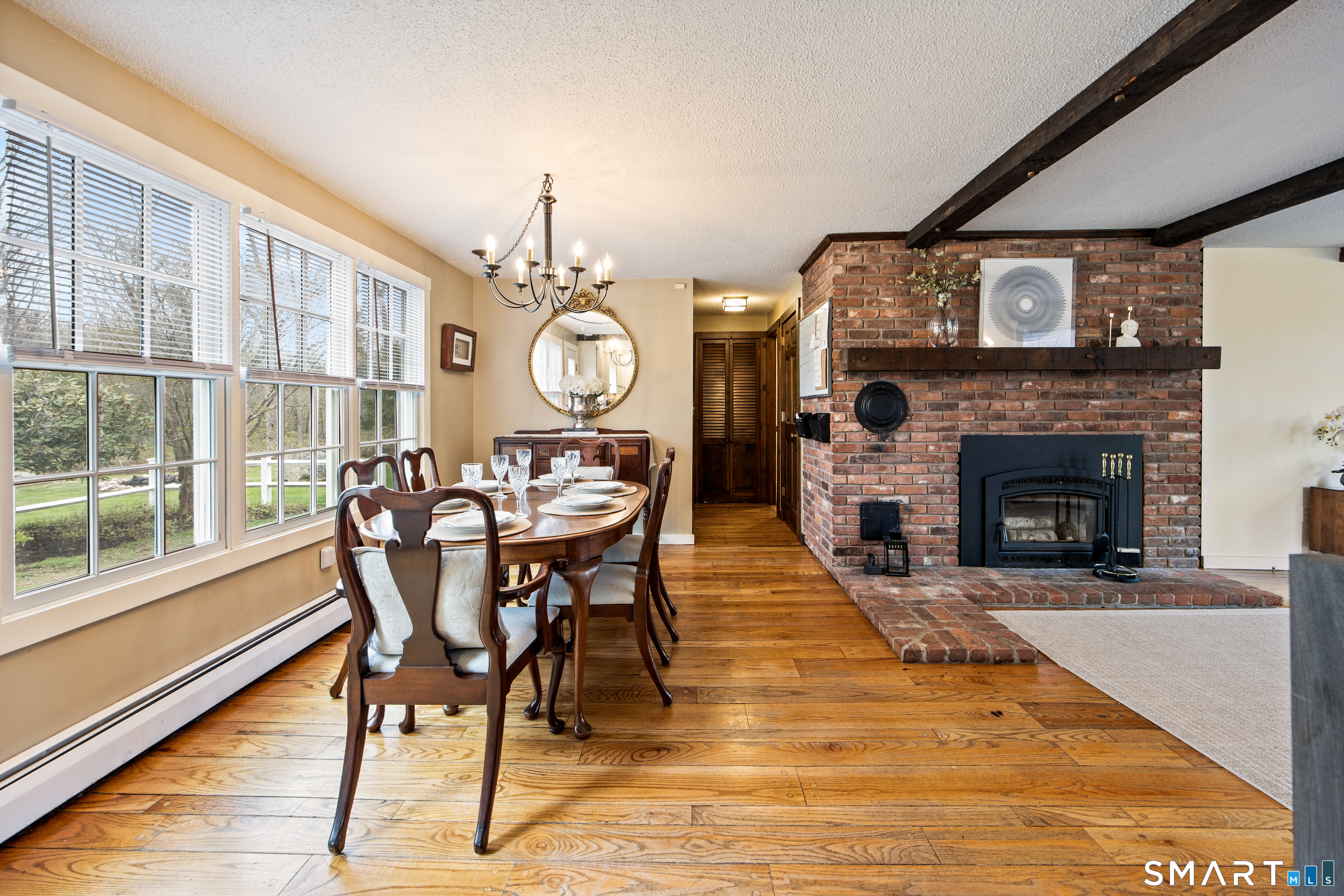 5 Livery Pool Road New Hartford, CT 06057 - Photo 16 of 40 a dining room with furniture a fireplace and wooden floor
