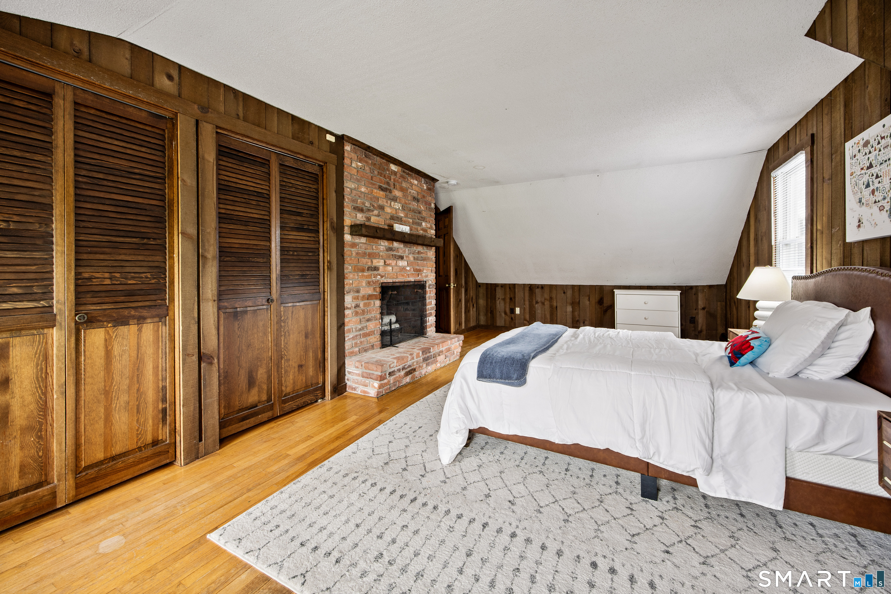 5 Livery Pool Road New Hartford, CT 06057 - Photo 30 of 40 a bedroom with a bed and a dresser with wooden floor