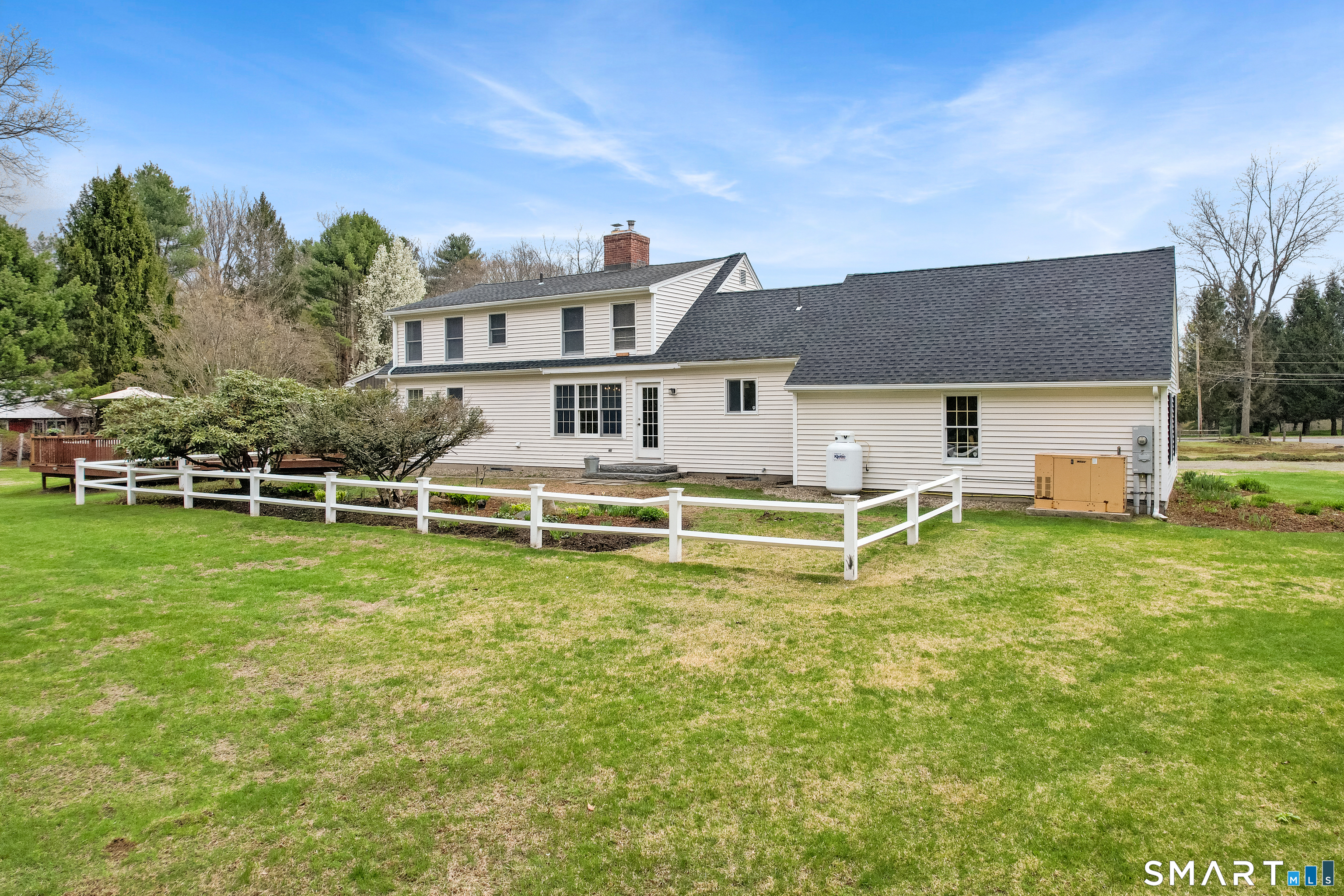 5 Livery Pool Road New Hartford, CT 06057 - Photo 36 of 40 a view of a white house with a big yard and plants