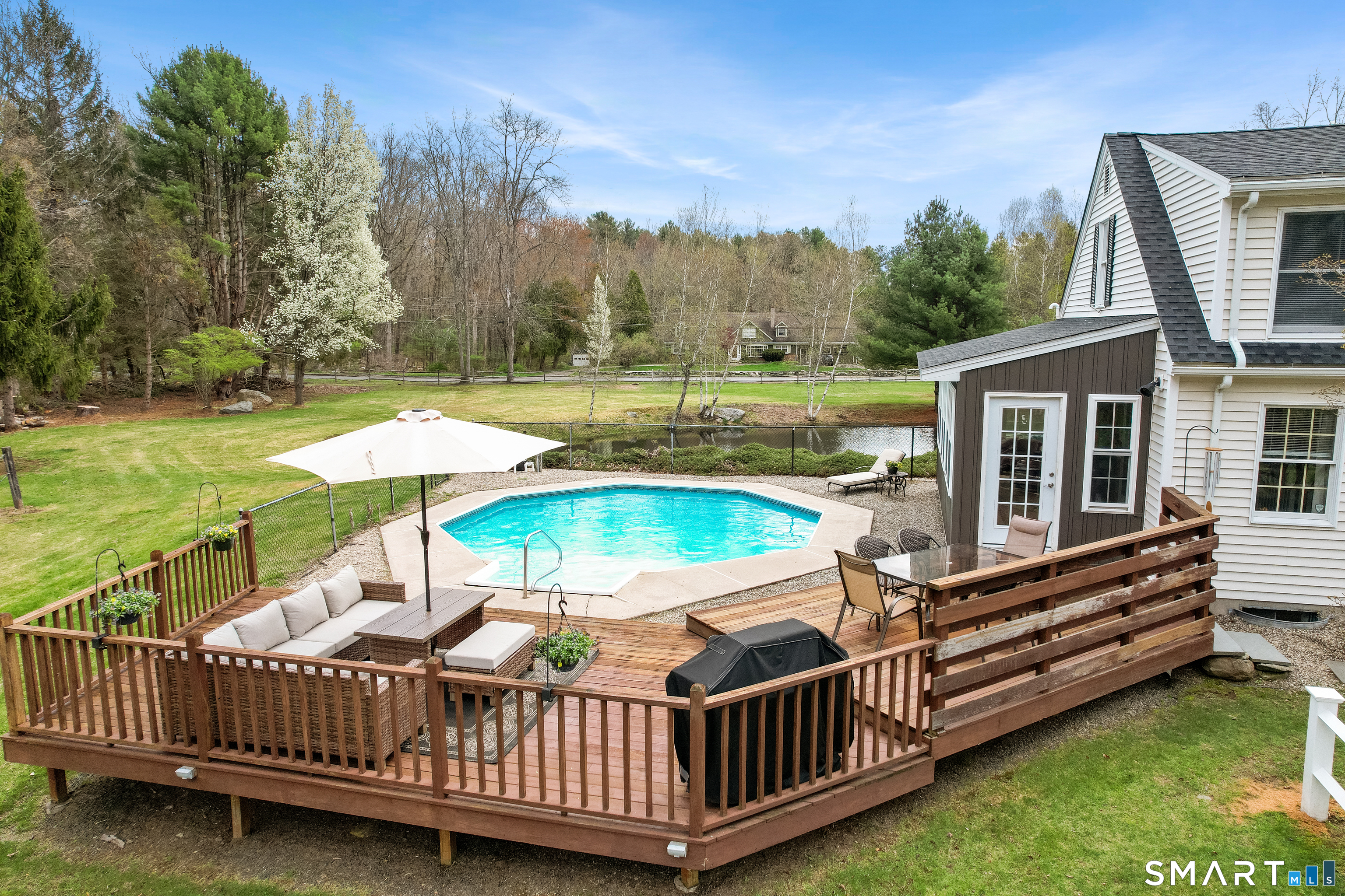 5 Livery Pool Road New Hartford, CT 06057 - Photo 6 of 40 a view of a house with wooden deck and a yard