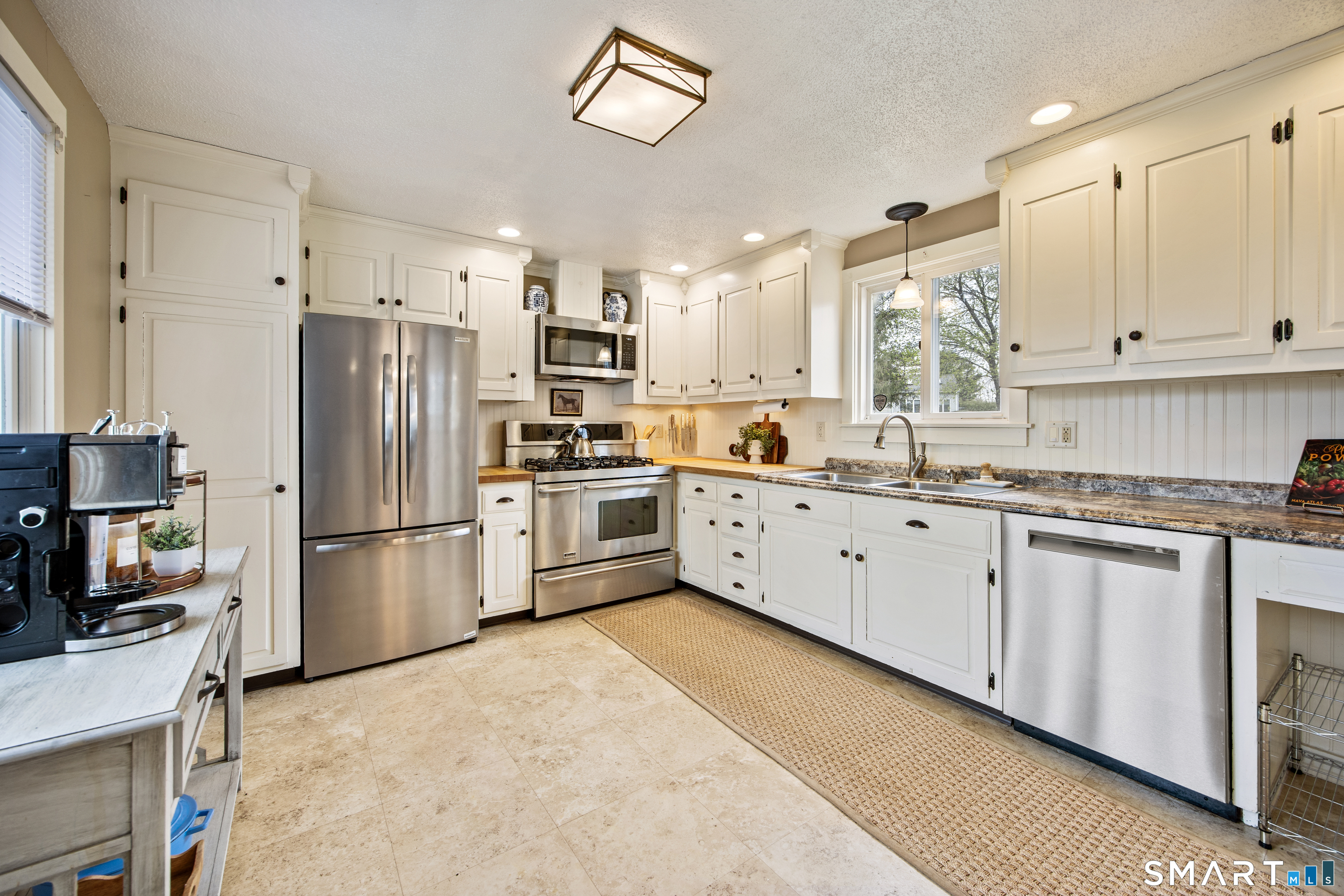 5 Livery Pool Road New Hartford, CT 06057 - Photo 10 of 40 a kitchen with white cabinets and white stainless steel appliances
