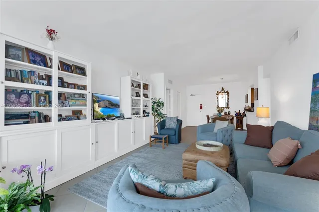 a living room with furniture and a book shelf