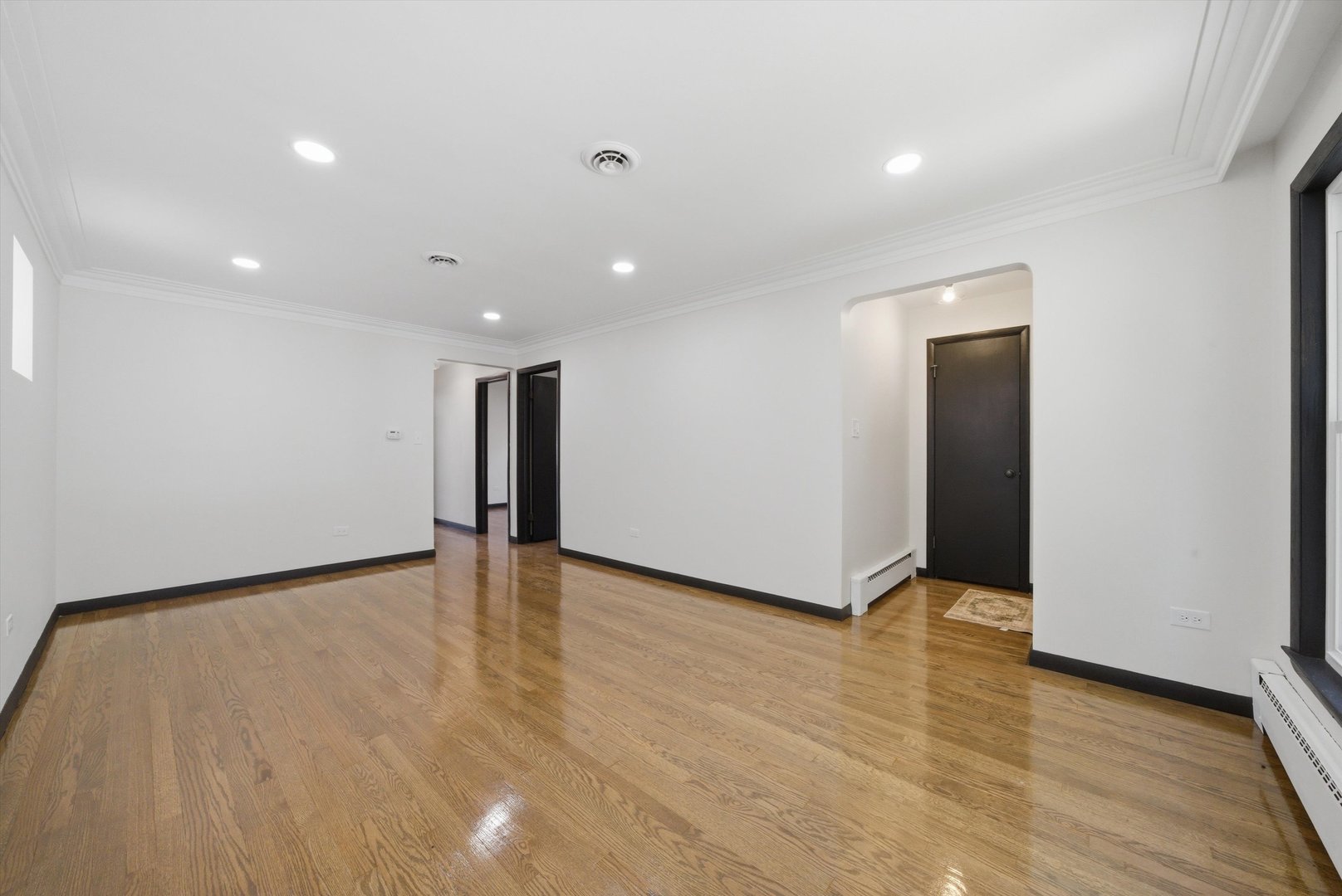 3907 West Marquette Road Chicago, IL 60629 - Photo 4 of 32 a view of an empty room with wooden floor