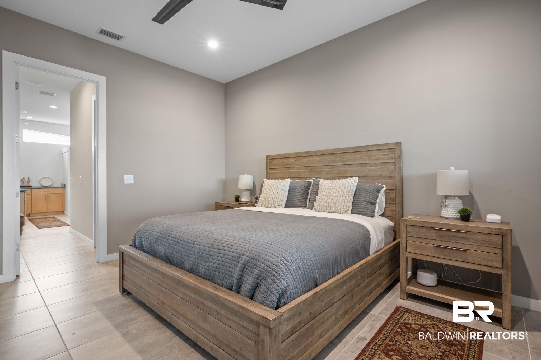3840 Cotton Way Orange Beach, AL 36561 - Photo 25 of 75 Bedroom featuring ceiling fan, light tile patterned floors, and ensuite bathroom