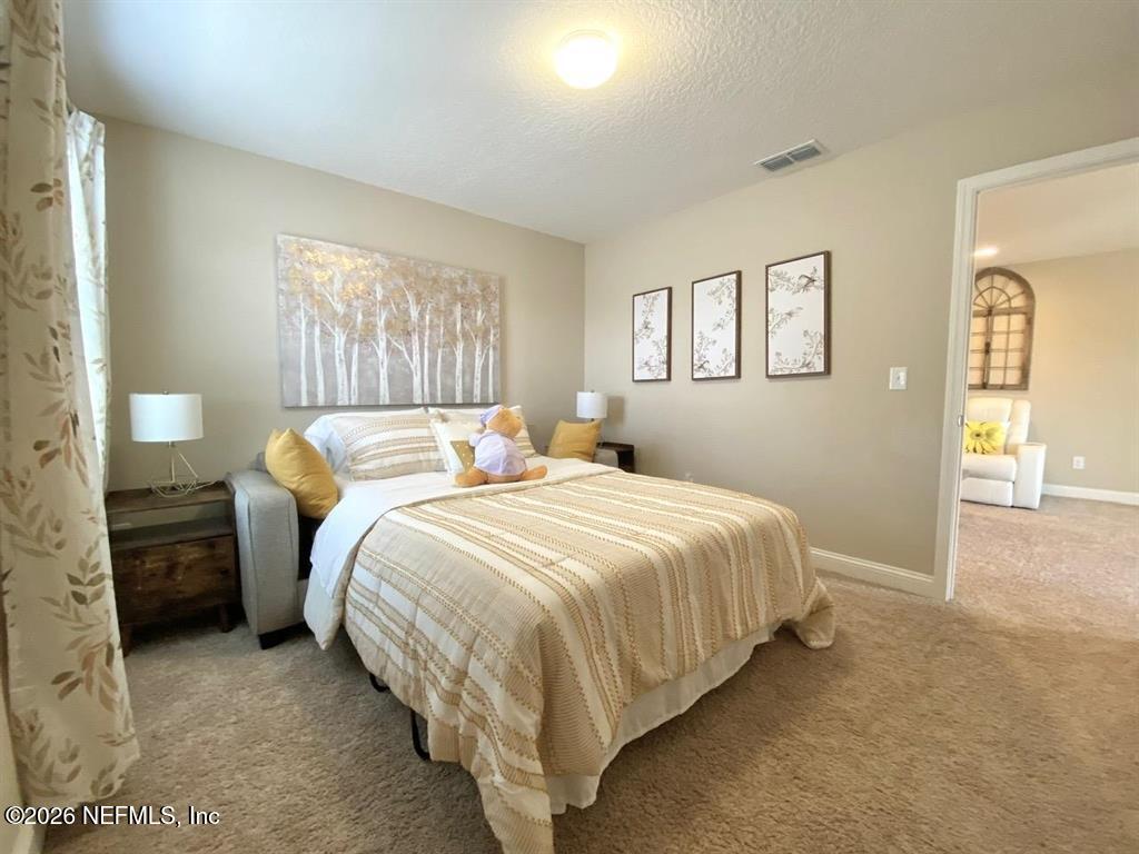 115 Sierras Loop St. Augustine, FL 32086 - Photo 39 of 65 a bedroom with a bed and a window