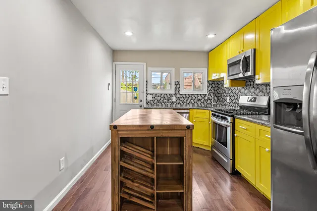 a view of a kitchen with a sink and a microwave