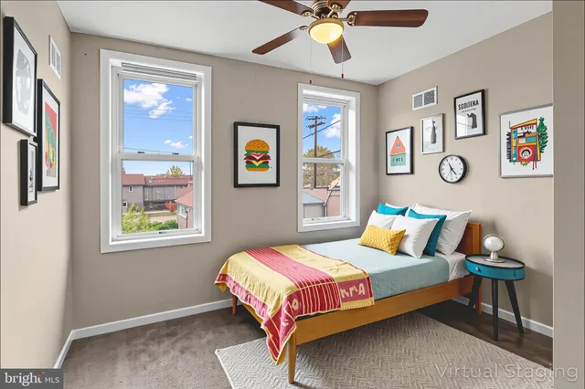 a bedroom with a bed and painting on the wall