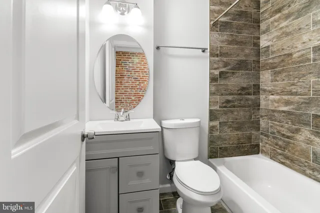 a bathroom with a toilet a sink and a shower