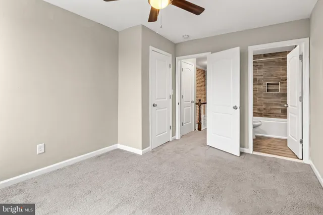 an empty room with closet and windows