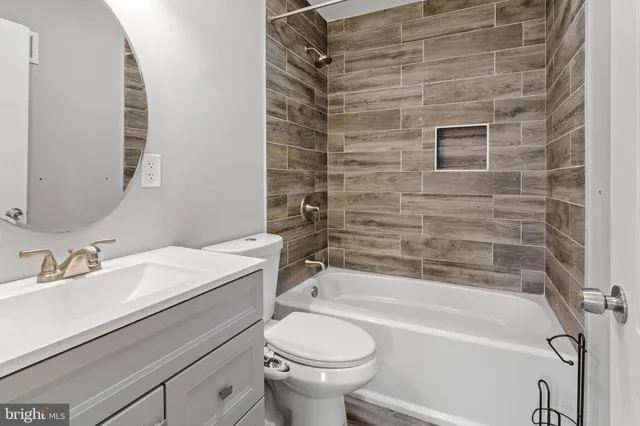 a bathroom with a sink toilet and bathtub