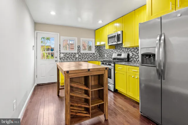 a kitchen with a sink appliances and cabinets