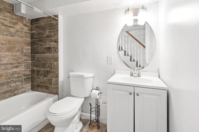 a bathroom with a sink a toilet and bathtub