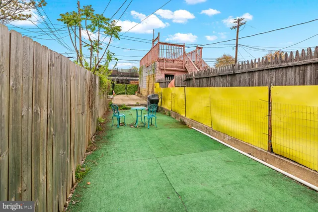 a view of a swimming pool with a bench and floor to ceiling window