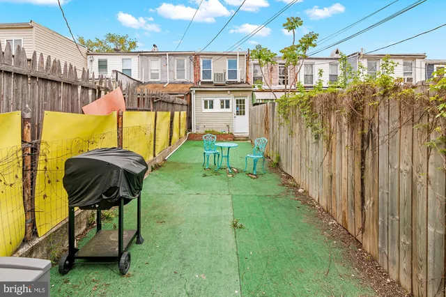 a view of a swimming pool with a chairs and table in the patio