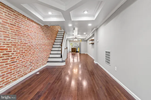 a view of a hallway with wooden floor