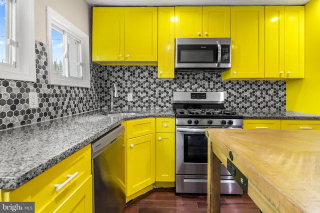 a bathroom with a sink a counter top space and a window
