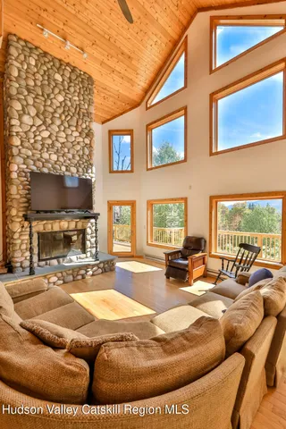 a living room with furniture a fireplace and a flat screen tv